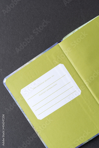 open notebook, inside cover, printed book plate, space for personal information in case of loss