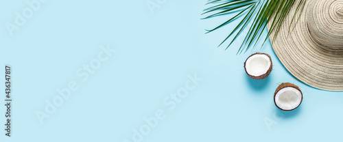 Canvas Print Women's hat with wide brim, sunglasses, coconut and a branch of a palm tree on a blue background