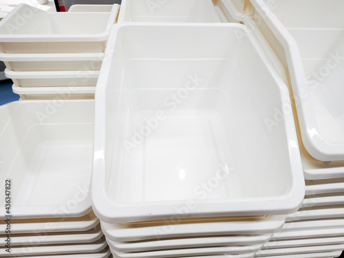 Stack of white plastic container box storage. Plastic containers for home use stack in a store for sale. Houseware store plastic containers.