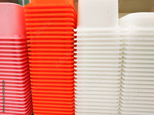 Stack of multi colors plastic container box storage. Plastic containers for home use stack in a store for sale. Houseware store plastic containers.