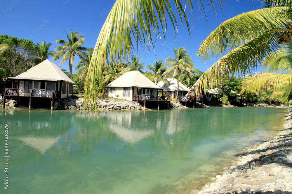 Little huts along the Island Canal with Palm Trees