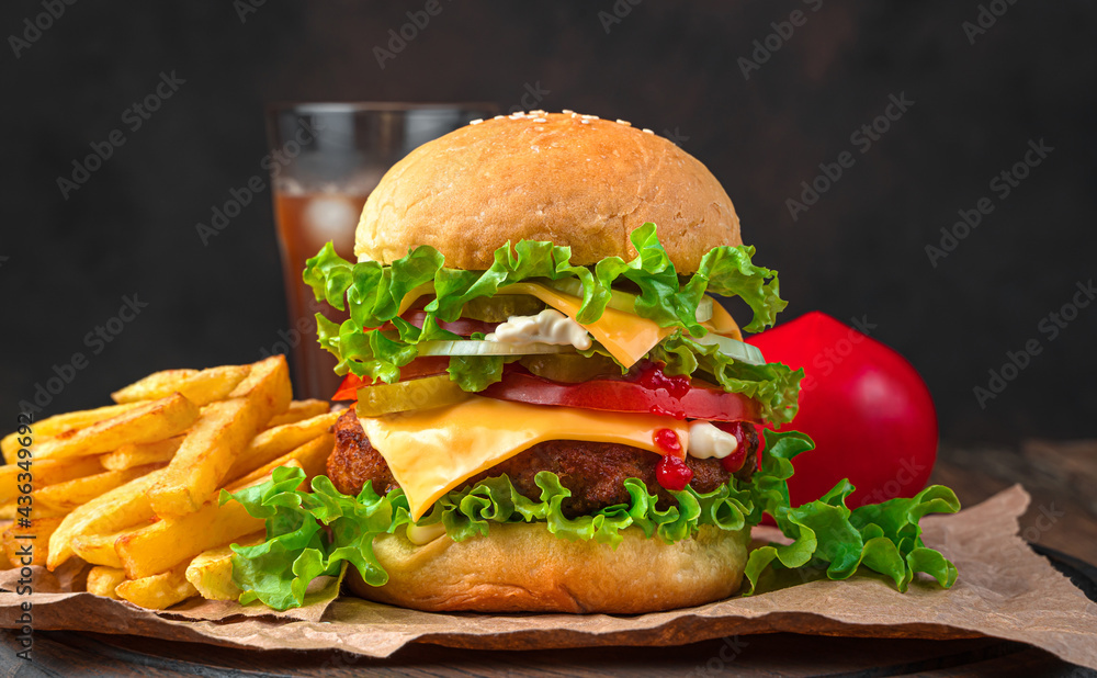Burger, French fries and cola on a brown background. Side view, horizontal. Burger, French fries and cola on a brown background. Side view, horizontal.