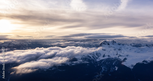 Aerial View from Airplane of Canadian Mountain Landscape in Spring time. Colorful Sunset Sky. Garibaldi Peak near Squamish and Vancouver, British Columbia, Canada. Authentic Image