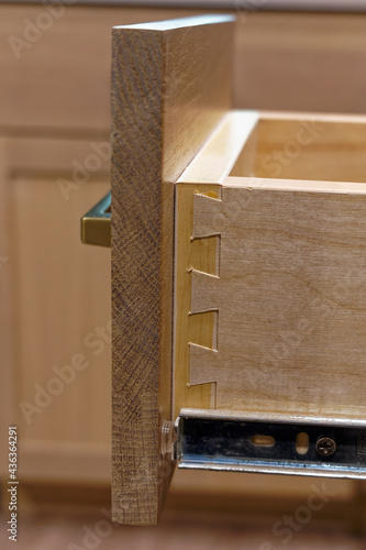 dovetail costruction of a wooden kitchen drawer photo