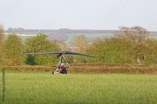 Valokuva Ultralight airplane landing on a grass strip