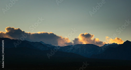 Canvas Print Sparse clouds catch the last rays of sun over the Andes mountains near Uspallata, province of Mendoza, Argentina