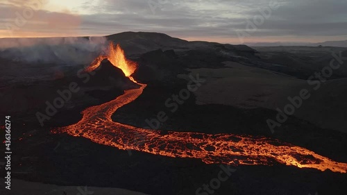 Aerial panoramic view of volcano erupting magma with sunset in background. Iceland photo