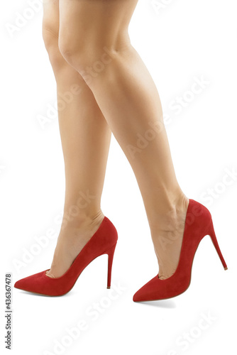 Beautiful female long legs in red suede fashionable high heel shoes on a white background, isolate