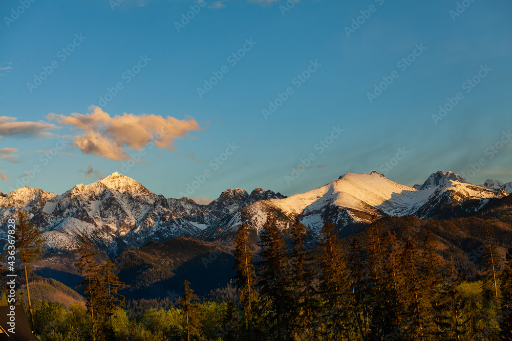 Beautiful view of the snow-capped peaks of the Tatra Mountains. Peaks illuminated by the setting sun. Poland