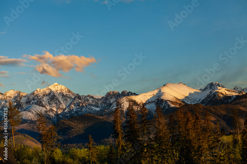 Beautiful view of the snow-capped peaks of the Tatra Mountains. Peaks illuminated by the setting sun. Poland