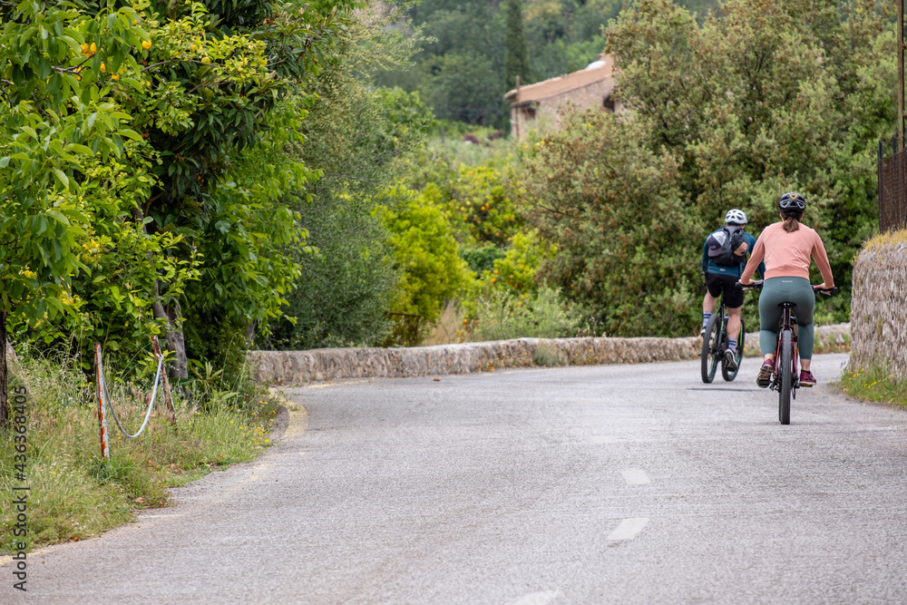two cyclists on the road, Fornalutx, Soller valley route, Mallorca, Balearic Islands, Spain