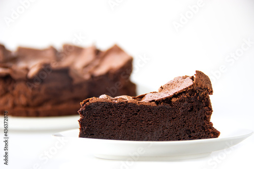 Fotografie Slice homemade flourless chocolate cake on white background