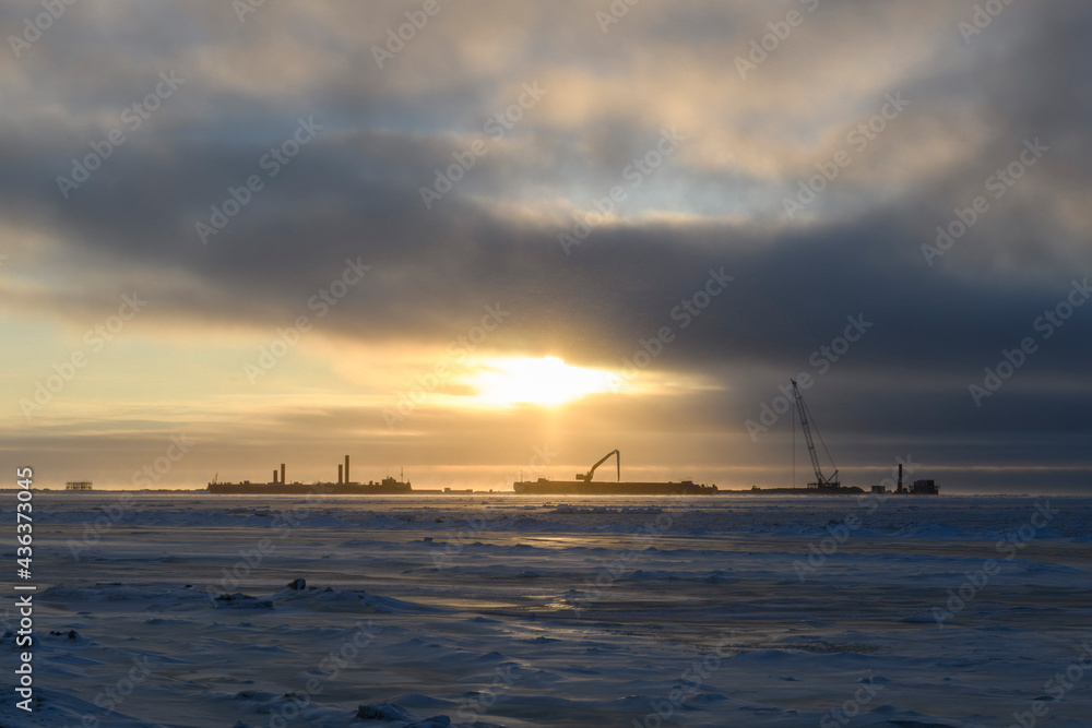 Barge with crane. Dredger working at sea. Sunset in Arctic sea. Construction Marine offshore works. Dam building, crane, barge, dredger.