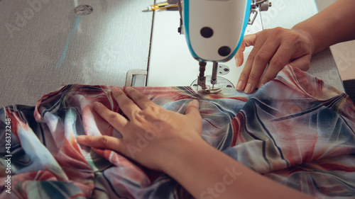 A seamstress quickly tailors the clothes. In order to deliver customers in time to see the top view photo