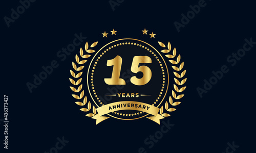 15th golden anniversary logo, with shiny ring and golden ribbon, laurel wreath isolated on navy blue background