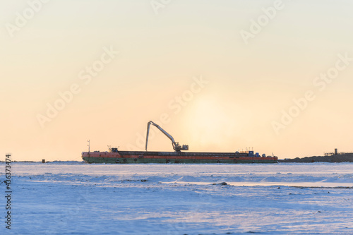  Barge with crane. Dredger working at sea. Sunset in Arctic sea. Construction Marine offshore works. Dam building, crane, barge, dredger. © Alexey Seafarer