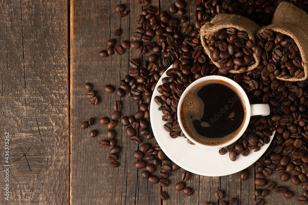 Coffee cup and beans on a rustic background. Espresso. Coffee cup and beans on a rustic background. Espresso.