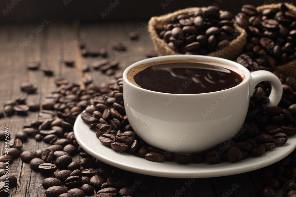 Coffee cup and beans on a rustic background. Espresso. Coffee cup and beans on a rustic background. Espresso.