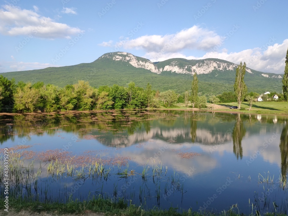 Crimean peninsula. Summer landscape in the mountainous Crimea with a lake, trees and clouds.