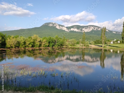 Crimean peninsula. Summer landscape in the mountainous Crimea with a lake, trees and clouds.