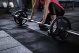 Cropped shot of unrecognizable sportswoman preparing to lift barbell at gym