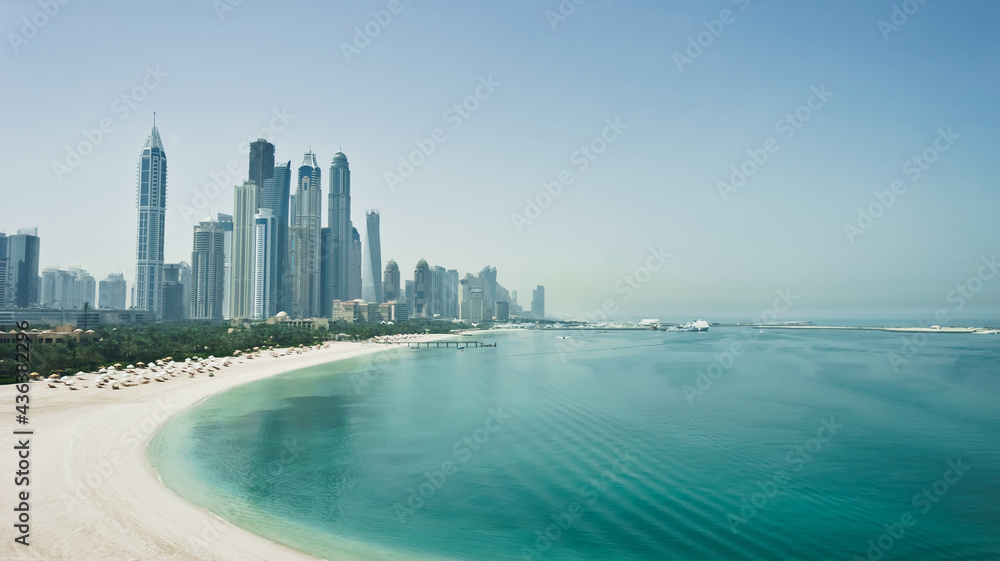 Dubai city skyline with skyscrapers, sea and beach. Travel, tourism, cityscape or business concept. Fastest growing city in the world. United Arab Emirates. High quality image