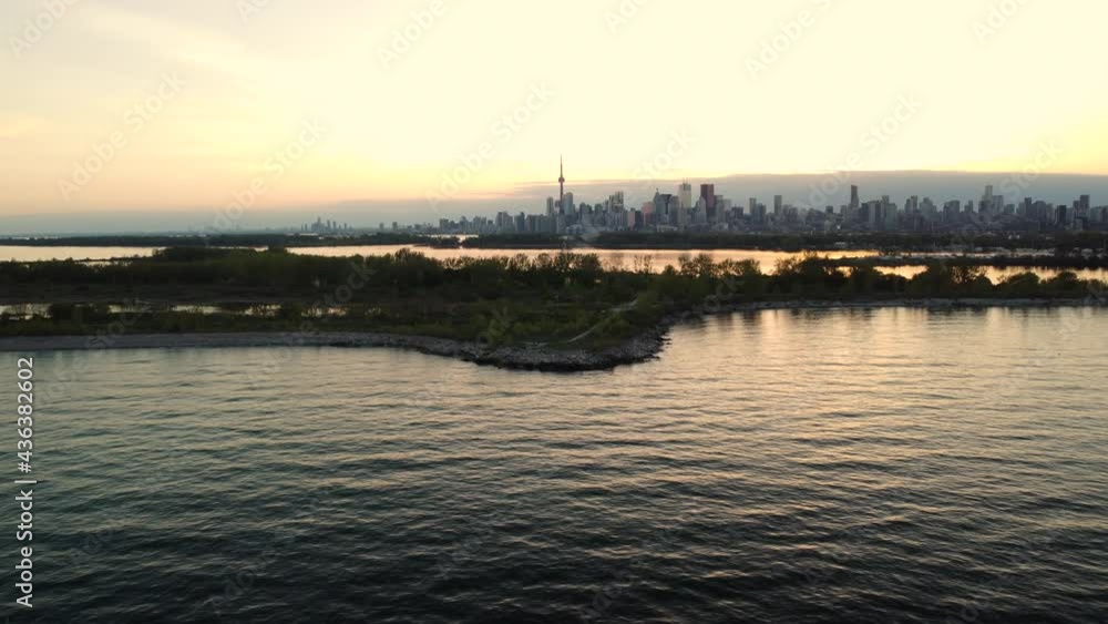A slow, dolly in aerial of downtown Toronto silhouetted against a sunset A slow, dolly in aerial of downtown Toronto silhouetted against a sunset