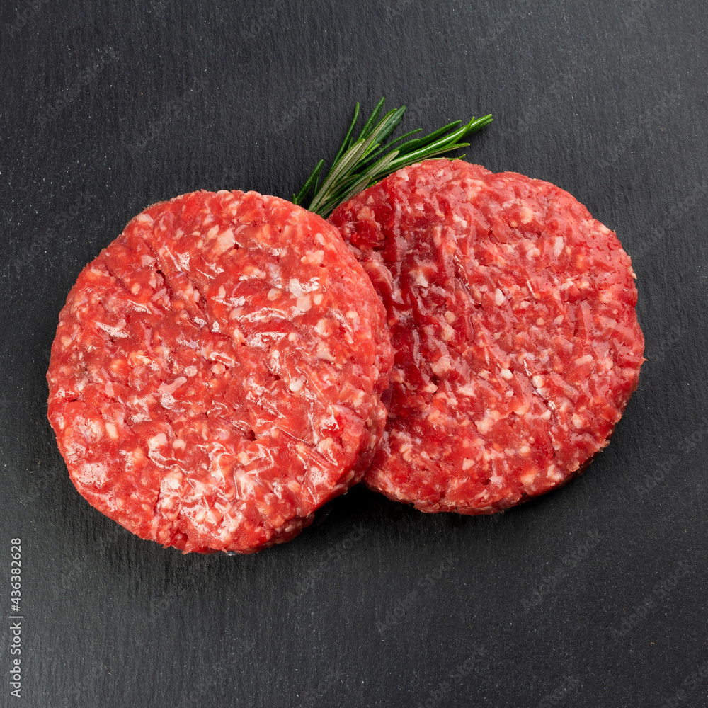 Hamburger meat with rosemary and black background Hamburger meat with rosemary and black background