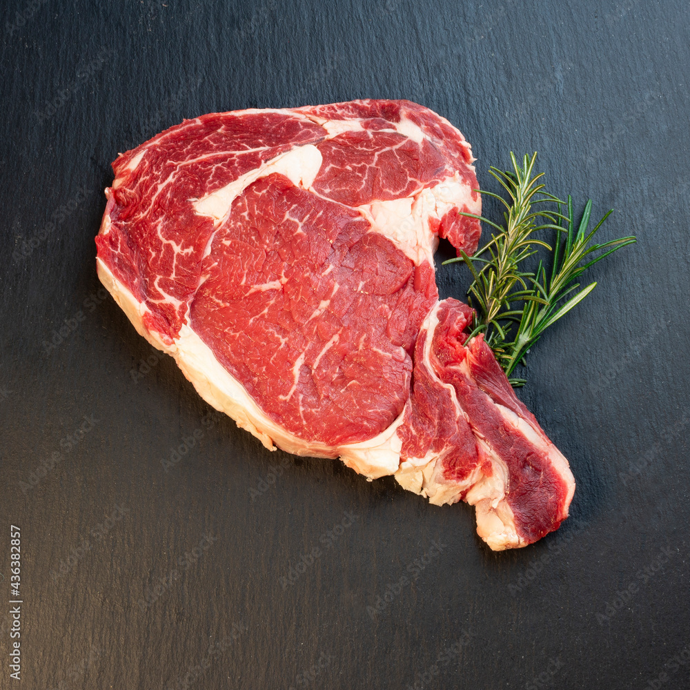 Meat with rosemary and black background