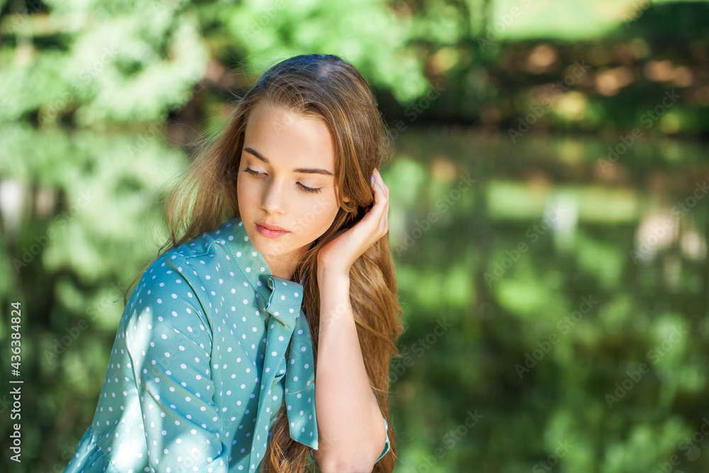Young beautiful blonde girl in turquoise dress Young beautiful blonde girl in turquoise dress