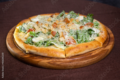 pizza with egg and green vegetarian salad.