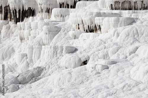 Close up of white limestone natural travertine terraces in pamukkale with pools full of carbonated water