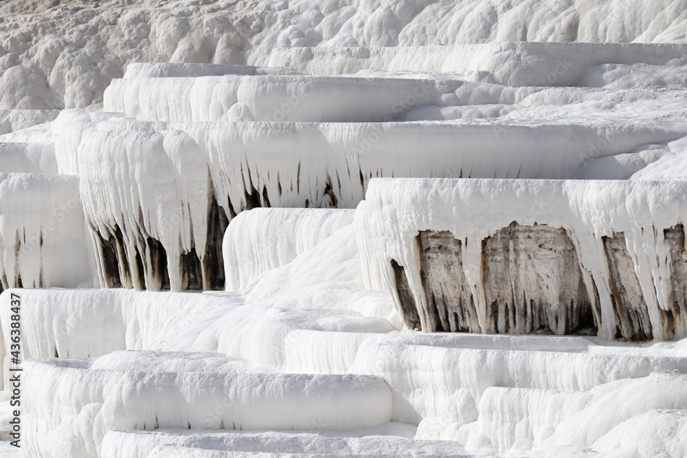 Close up of white limestone natural travertine terraces in pamukkale with pools full of carbonated water Close up of white limestone natural travertine terraces in pamukkale with pools full of carbonated water