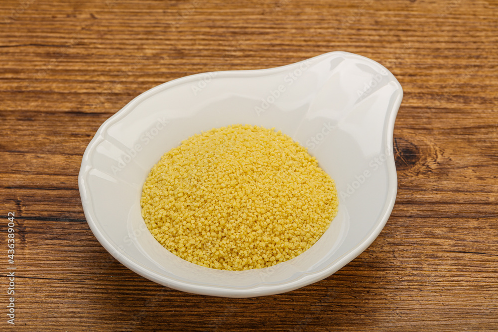 Raw cous cous heap in the bowl Raw cous cous heap in the bowl