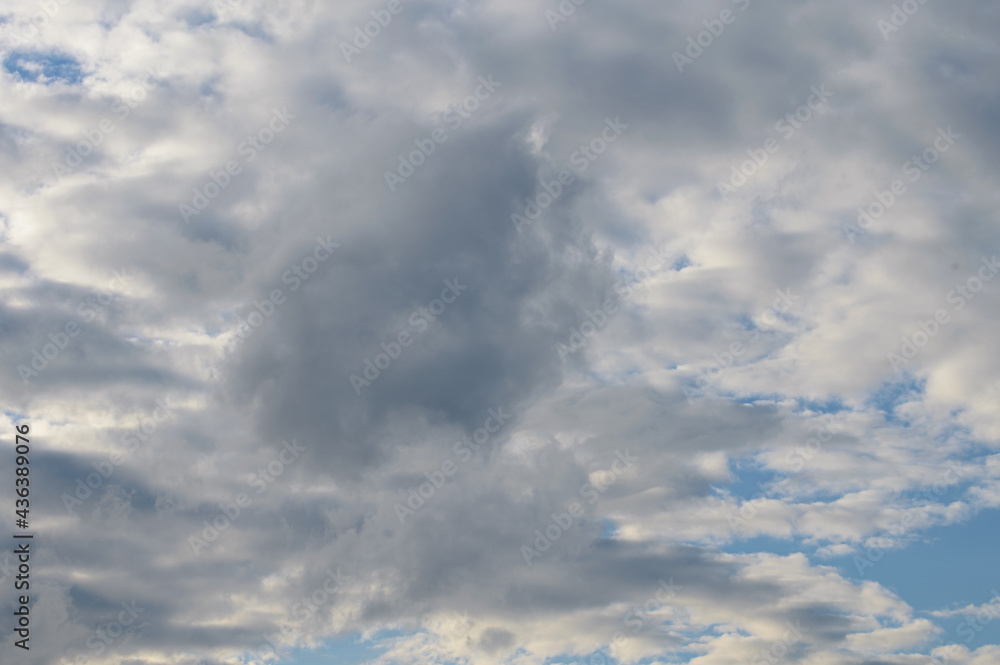 Abstract background of white fluffy clouds on a bright blue sky