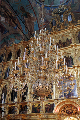 The Dormition Church Trinity Lavra of St. Sergius, interior of Assumption Cathedral. Walls with frescoes depicting saints and iconostasis with ancient icons photo