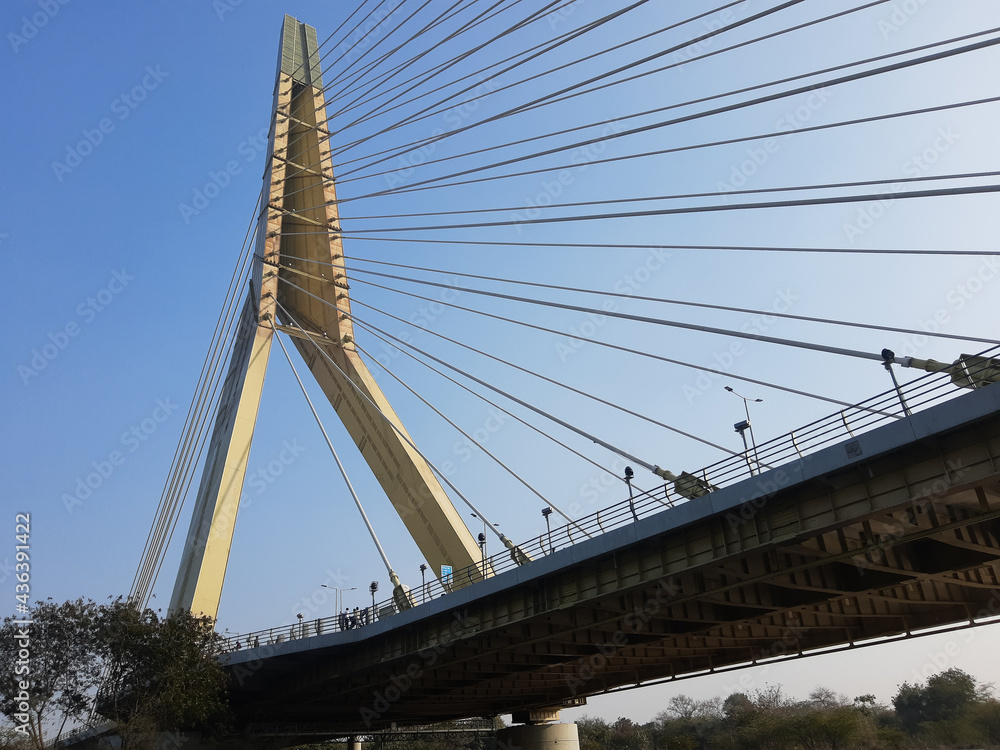 Fototapeta premium Signature Bridge is a cantilever spar cable-stayed bridge which spans the Yamuna river at Wazirabad section, connecting Wazirabad to East Delhi.