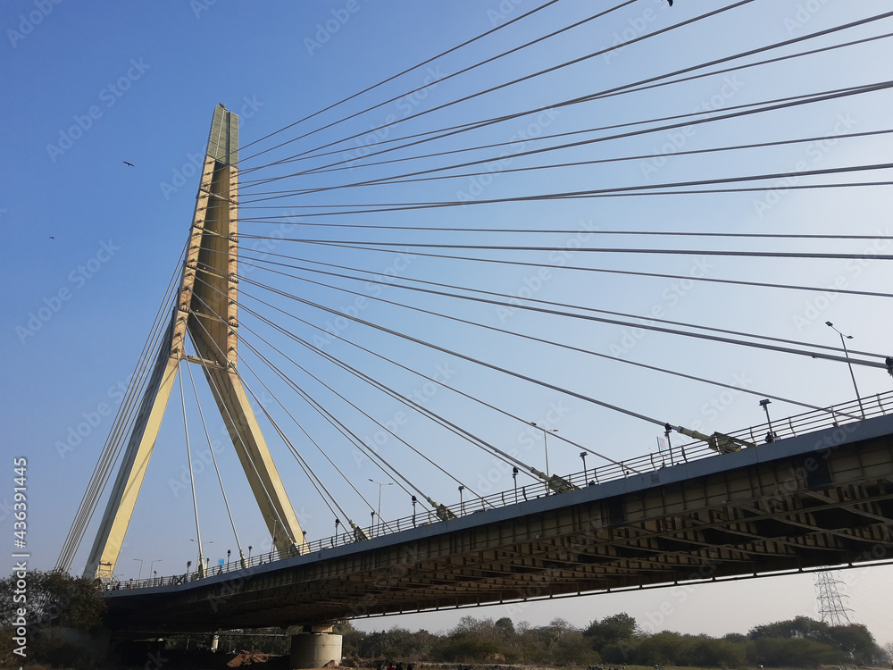 Naklejka premium Signature Bridge is a cantilever spar cable-stayed bridge which spans the Yamuna river at Wazirabad section, connecting Wazirabad to East Delhi.