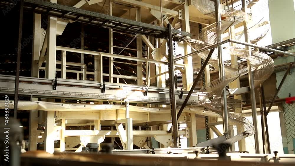 Square fresh bread on conveyor automatic production line bakery after stone oven, sunlight. Square fresh bread on conveyor automatic production line bakery after stone oven, sunlight.