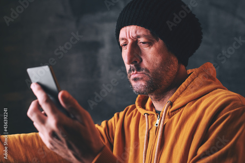 Man reading text message on mobile phone