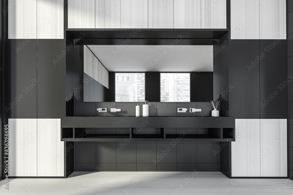 Modern design bathroom interior with double sink countertop, silver faucets, big mirror. Black tile and wooden panels walls. Public wc hands wash concept. Modern design bathroom interior with double sink countertop, silver faucets, big mirror. Black tile and wooden panels walls. Public wc hands wash concept.