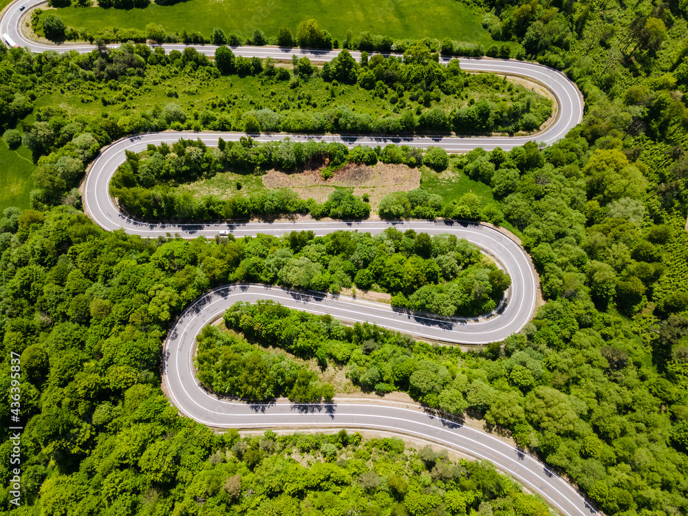 Winding Curvy Road Trough Green Forest. Top Down Drone Perspective View Winding Curvy Road Trough Green Forest. Top Down Drone Perspective View