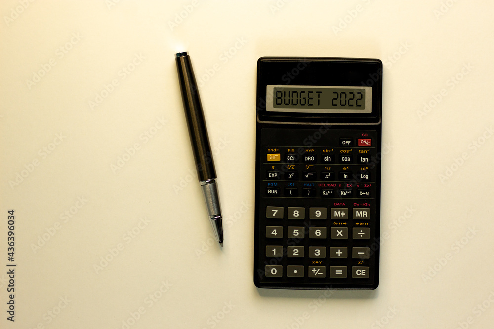 Business concept of budget planning 2022. Calculator with words 'budget 2022', metalic pen. Business, budget 2022 concept. Beautiful white background, copy space. Business concept of budget planning 2022. Calculator with words 'budget 2022', metalic pen. Business, budget 2022 concept. Beautiful white background, copy space.