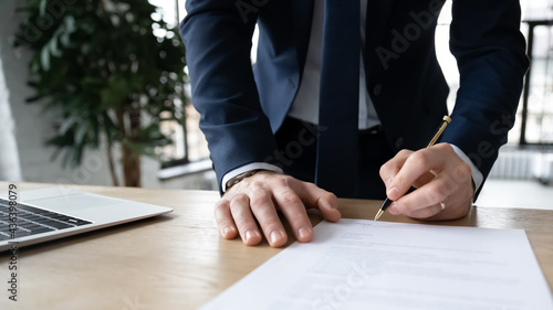 Company executive, business owner, employer signing contract, agreement, paper report at workplace. Businessman affixing signature, hiring employee, buying or selling project, closing deal. Close up