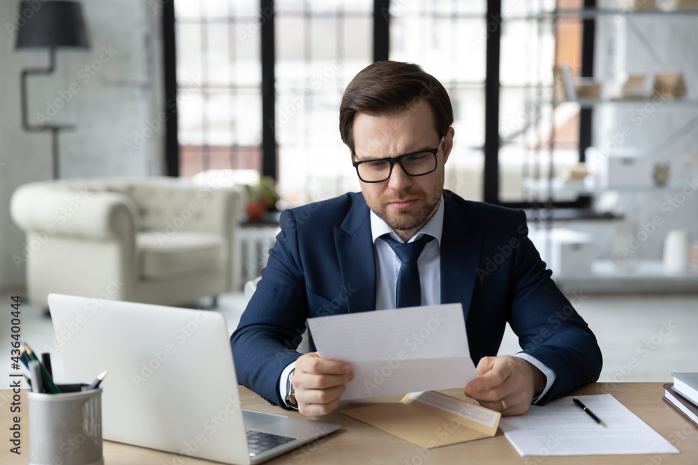 Φωτογραφία Frustrated businessman receiving mail with bad concerning news, learning about loan, mortgage rejection, bankruptcy, financial loss