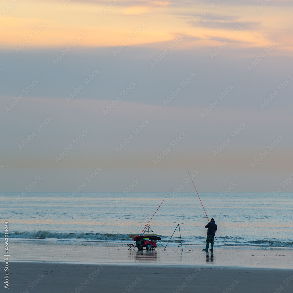 Silhouette of a fisherman with fishing line along the North Sea beach, Oostende (Ostend), Belgium. Silhouette of a fisherman with fishing line along the North Sea beach, Oostende (Ostend), Belgium.