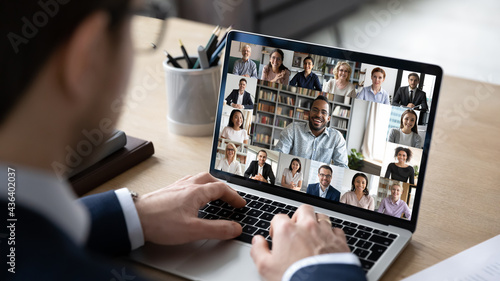 Businessman talking to team of colleagues on online video conference call on laptop. Screen view of coach, teacher and students attending webinar. Distance business meeting, remote work concept photo