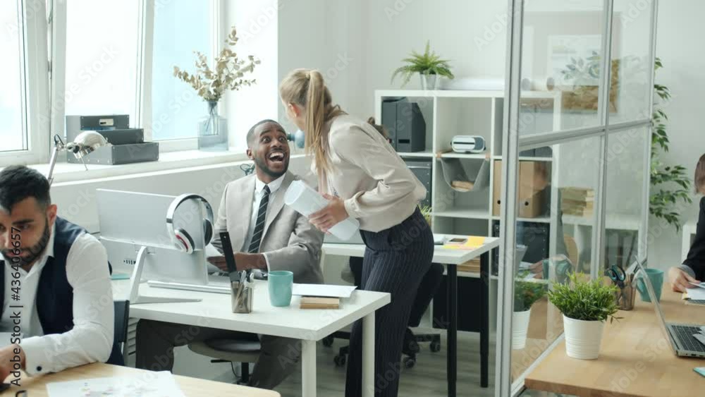 Multi-ethnic business team getting good news throwing papers and dancing enjoying success together. Positive emotions and business activities concept. Multi-ethnic business team getting good news throwing papers and dancing enjoying success together. Positive emotions and business activities concept.