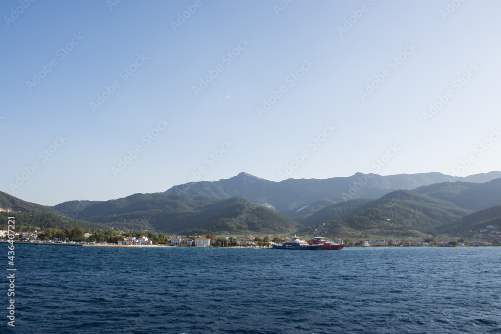 Island Thassos, Greece - Two ferries docked in the port of Island Thasos, ferryboat transportation, Greek hills, mountains, harbor