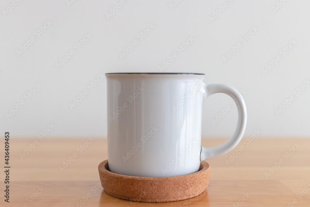 White cup of hot coffee mug on wooden table with isolate white background. White cup of hot coffee mug on wooden table with isolate white background.
